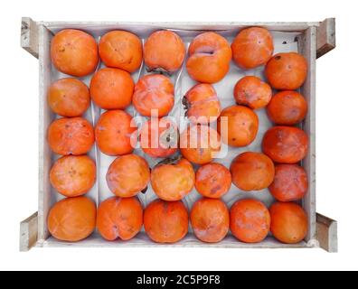 Persimmon fruit in the wooden box isolated on white. Clipping Path included Stock Photo