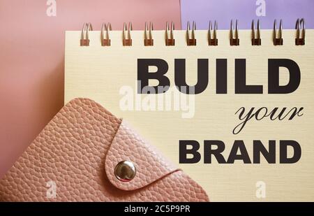Build Your Brand text on a page of copybook and wallet. business concept Stock Photo