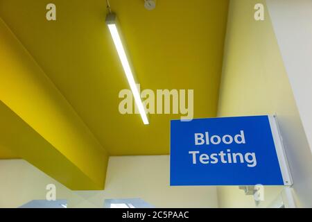 A Blood Testing sign in an NHS drop in centre Stock Photo