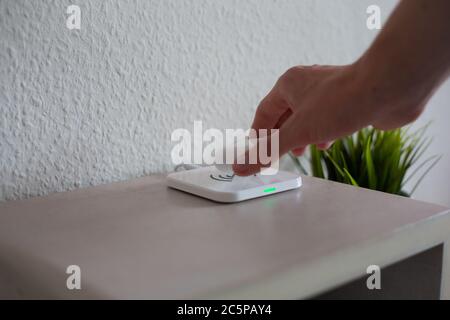Wireless Headphones being placed on wireless charging pad to charge battery Stock Photo