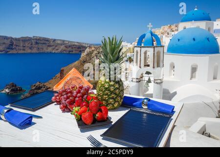 Summer berries and pineapple on the table against the sea Stock Photo