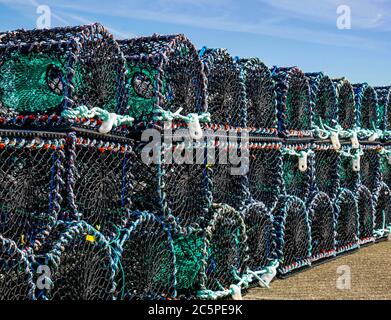 Stacked rows of lobster pots, cages or creels, Anstruther village harbour, Fife, Scotland, UK on a sunny day Stock Photo