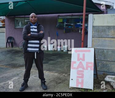 John Lusamba Mbombo, a South African business owner at his place of work.  He runs a successful car wash business in Cape Town, South Africa. Stock Photo