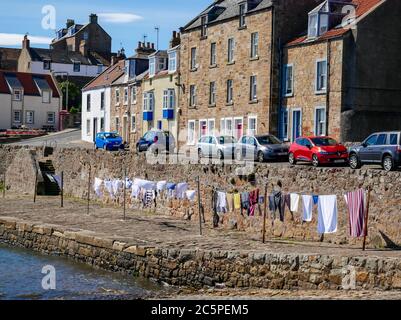 Washing hanging to dry on communal clotheslines in harbour, Anstruther, Fife, Scotland, UK Stock Photo