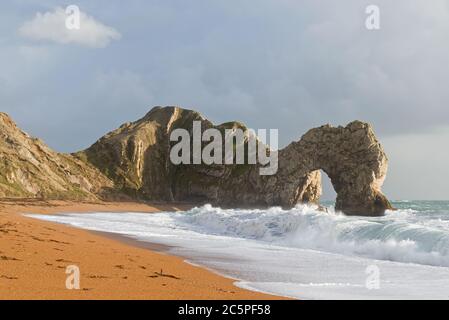 The distinctive limestone arch at Durdle Door in Dorset on the Jurassic Coast. Part of the Dorset AONB and is on the route of South West Coast Path. Stock Photo
