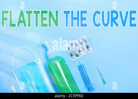 Writing note showing Flatten The Curve. Business concept for raising an awareness on slowing the rate of the infectious disease Primary medical precau Stock Photo