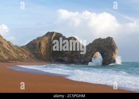 The distinctive limestone arch at Durdle Door in Dorset on the Jurassic Coast. Part of the Dorset AONB and is on the route of South West Coast Path. Stock Photo