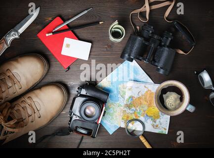 Preparation for travel. Outfit of traveler. Essential vacation items on wood table background. Flat lay. Stock Photo