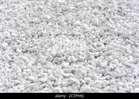 Small white stones on the ground on a close up shot Stock Photo