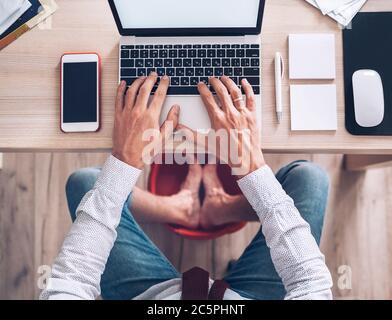Legs and feet, view under table Stock Photo - Alamy
