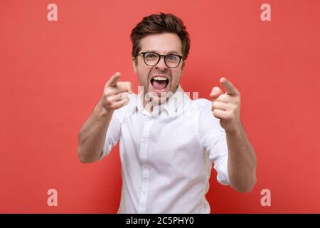 smiling man pointing fingers at camera, picking you Stock Photo