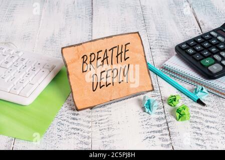 Word writing text Breathe Deeply. Business photo showcasing to take a lot of air into the lungs inhaleexhale fully Notepaper stand on buffer wire in b Stock Photo