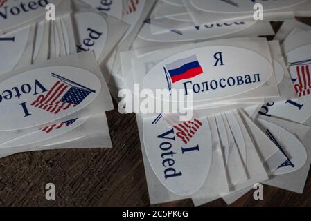 Pile of I voted stickers with American flags containing one Russian federation flag and Russian words saying I voted to symbolize controversial foreig Stock Photo