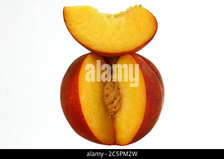 Peach cut with clove and stone, fresh fruit Stock Photo