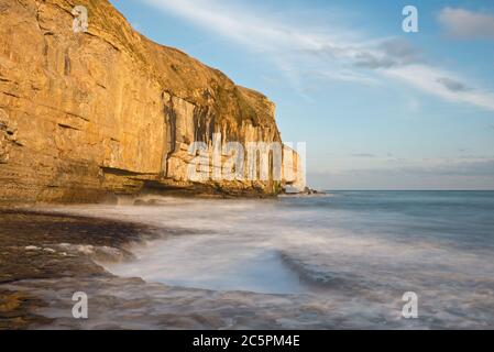 the rock ledge, waves and cliffs at Dancing Ledge on the Dorset coast close to Swanage on a fine sunny autumnal day Stock Photo