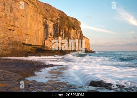 the rock ledge, waves and cliffs at Dancing Ledge on the Dorset coast close to Swanage on a fine sunny autumnal day Stock Photo