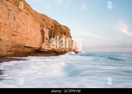 the rock ledge, waves and cliffs at Dancing Ledge on the Dorset coast close to Swanage on a fine sunny autumnal day Stock Photo