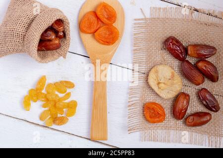 Dried fruits mix in burlap bags, zero waste concept. Flat lay Stock Photo
