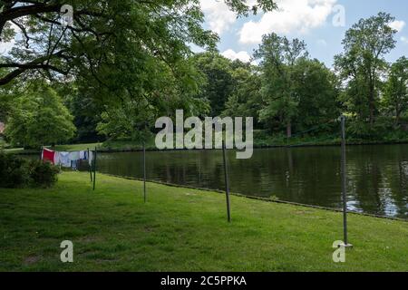 Clothesline with hanging laundry on the river trave in the old town centre of the hanseatic city Luebeck, Germany, selected focus Stock Photo