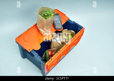 Plastic box with products. Food delivery in platinum boxes. Safe delivery. Storage of fragile goods Stock Photo