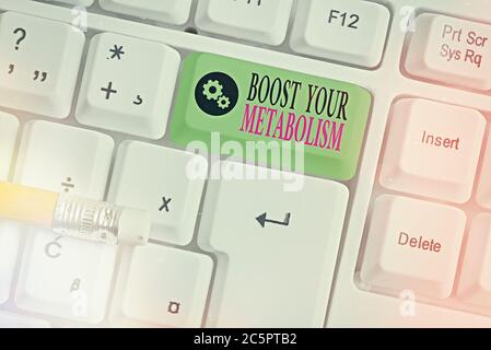 Writing note showing Boost Your Metabolism. Business concept for body process uses to make and burn energy from food Colored keyboard key with accesso Stock Photo