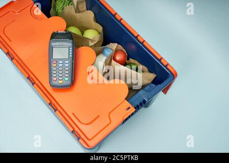 Plastic box with products. Food delivery in platinum boxes. Safe delivery. Storage of fragile goods. Stock Photo