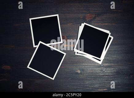 Blank photo frames. Square frames template on vintage wooden background. Flat lay. Stock Photo