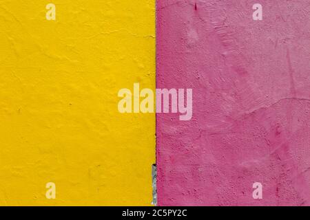 A bright yellow and pink painted wall Stock Photo