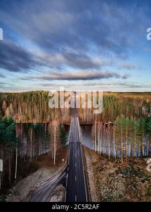 Aerial view of forest and road through the forest in the countryside. Stock Photo