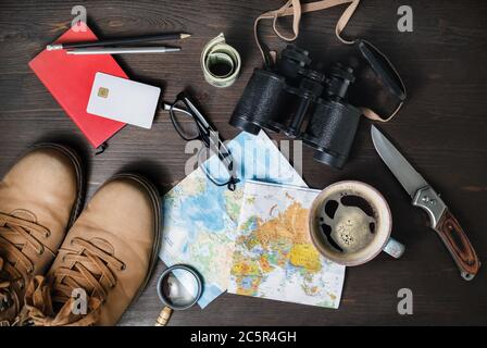 Outfit of traveler on wooden background. Tourism concept. Travel accessories and items. Top view. Flat lay. Stock Photo