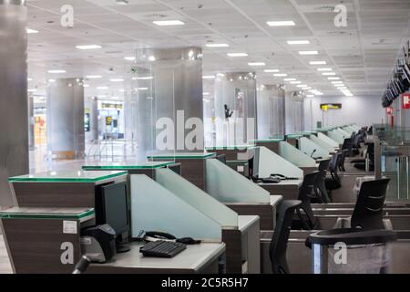 Empty unused terminal, lonuge, check in desks at Tenerife South airport, departures area, due to coronavirus Covid-19 outbreak travel restrictions. Stock Photo