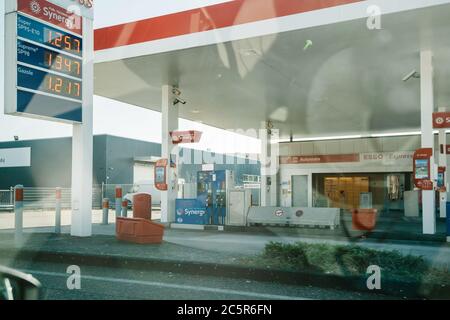 Haguenau, France - Ap 1, 2020: Esso gas station seen through car window with gas prices during Coronavirus Lockdown Stock Photo