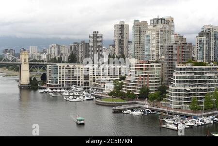 A view over the waters of False Creek, the Burrard Street Bridge and residential apartment and condominuim towers and boats docked at marinas in Vanco Stock Photo