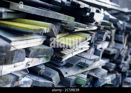 Stacked old boards of disassembled constructions will be used as firewood Stock Photo