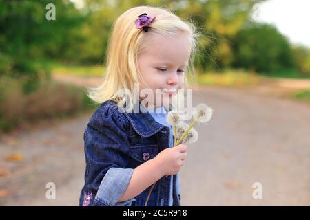 Portrait of a beautiful blonde girl outdoors in summer Stock Photo