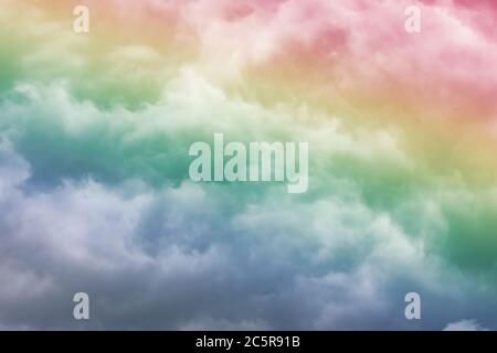 Fluffy white clouds in a bright blue sky.  Dramatic and colorful cloud background with mixed pastels. Stock Photo