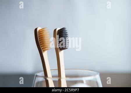 Toothbrushes in glass on blurred background Stock Photo