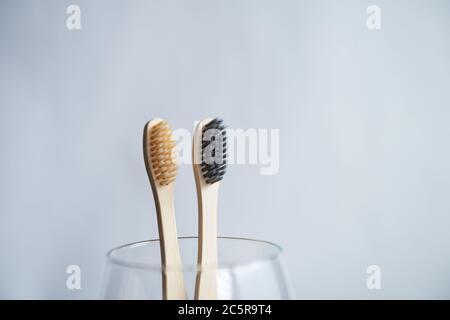 Toothbrushes in glass on blurred background Stock Photo