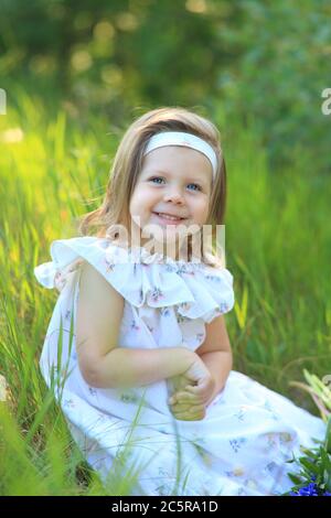 Portrait of a cute girl with lupine flowers in her hands Stock Photo