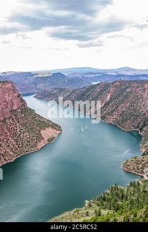 Above view from Canyon Rim Campground in Flaming Gorge Utah National Park of Green River high angle aerial overlook in evening with boats in water Stock Photo