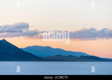 Bonneville Salt Flats basin colorful blue red twilight silhouette mountain view after sunset near Salt Lake City, Utah with clouds Stock Photo