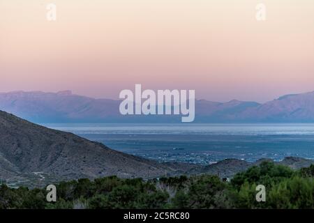 La Luz, New Mexico town view of Organ Mountains and White Sands Dunes National Monument at twilight sunset high angle above perspective with horizon Stock Photo