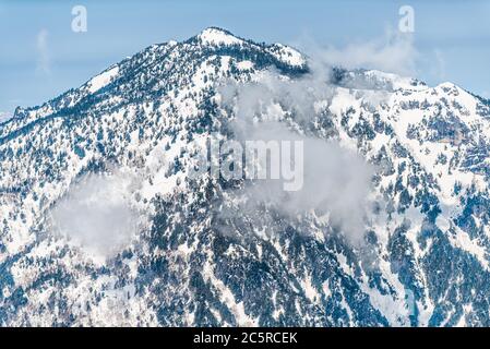 Mountain with clouds and snow view from Shinhotaka Ropeway in Gifu Prefecture, Japan park with blue sky on spring day Stock Photo
