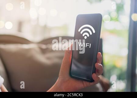 Wifi sign icon and connection screen of smartphone with top view city background. Financial business technology freedom dream life using internet free Stock Photo