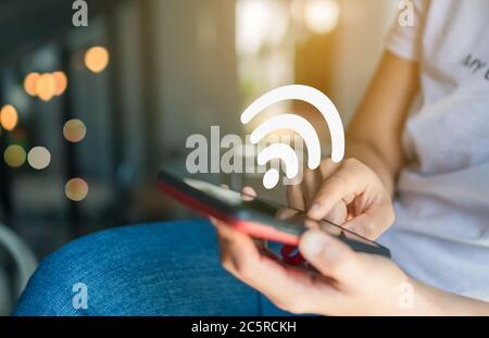 Wifi sign icon and connection screen of smartphone with top view city background. Financial business technology freedom dream life using internet free Stock Photo