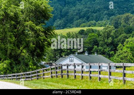 Farm house wooden fence in Roseland, Virginia near Blue Ridge parkway mountains in summer with idyllic rural landscape countryside in Nelson County