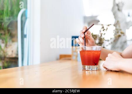 Women drink Juicy strawberry mixed juicy peach. Drink refreshment at sunny day.