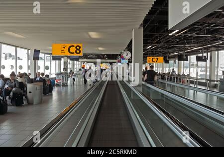 AMSTERDAM, NETHERLANDS - JUNE 12, 2014: Escalator for the movement of passengers between terminals. Schiphol is Europe's fifth busiest airport, it was Stock Photo