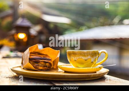 coffee and bread in wood plate on the table in the morning. Stock Photo