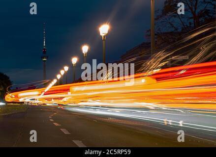 Berlin, Germany. 05th July, 2020. The vehicles on Karl Marx Allee in the direction of the television tower can only be recognised as coloured light strips. (shot with long time exposure) Credit: Paul Zinken/dpa/Alamy Live News